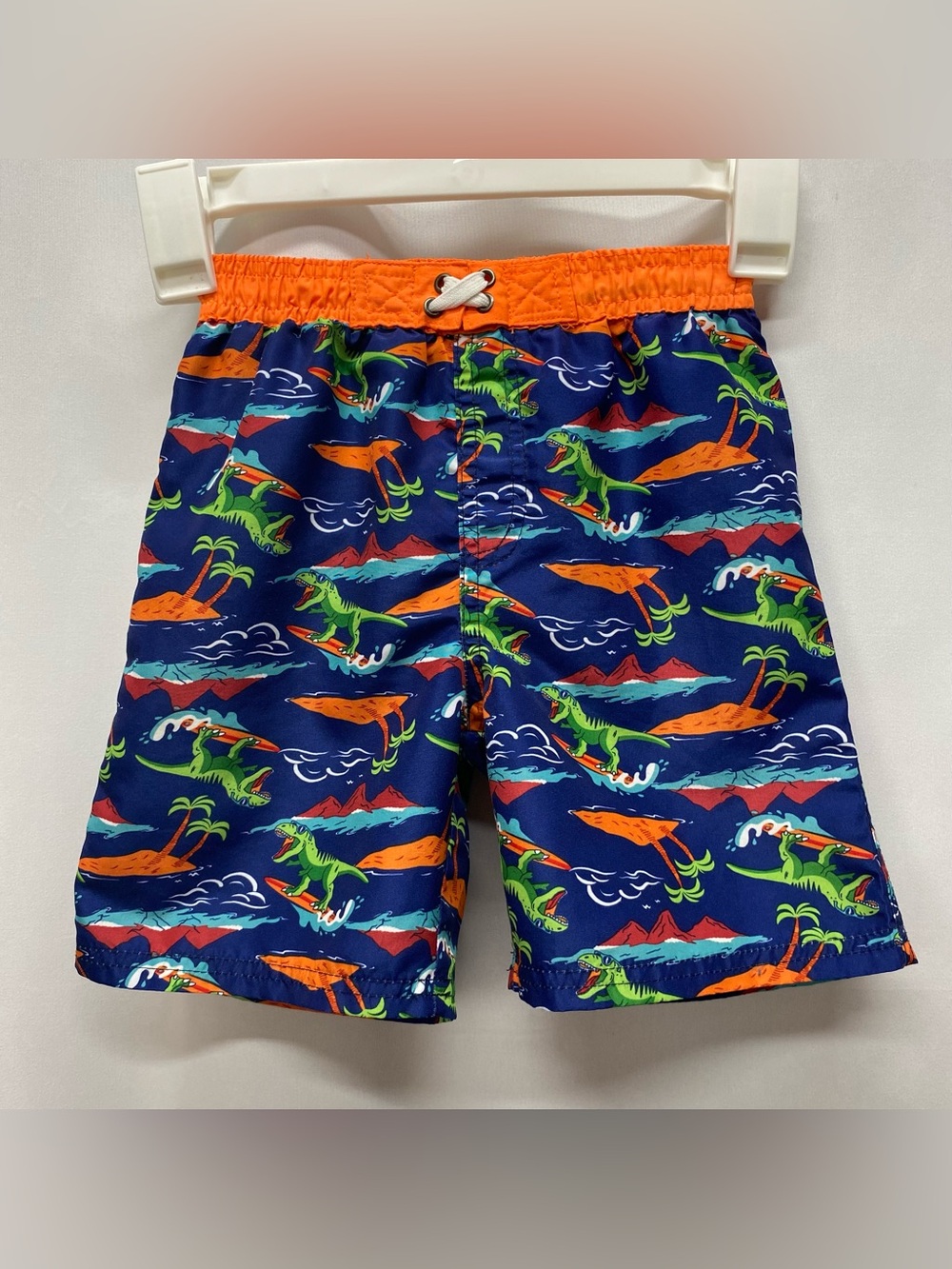 Dinosaur surfing swim trunks boys 5-6 blue orange beach palm trees swimsuit